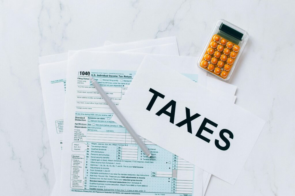 U.S. tax forms and calculator highlighting importance of tax preparation and IRS compliance.